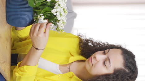 Vertical-video-of-A-young-woman-who-loves-flowers.